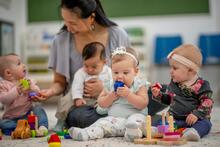 assistante maternelle entourée d'enfants